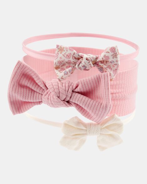 Set de diademas y lazos Carter's para bebé en rosa y crema, con diseños lisos, acanalados y florales.