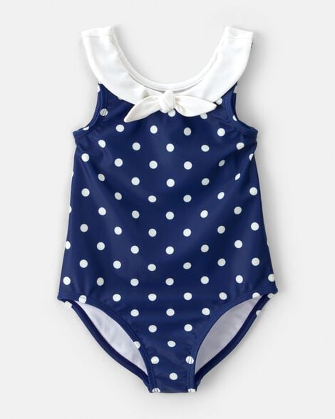Calzoneta Carters de niña azul con puntos blancos, cuello y lazo. Ideal para piscina o playa.