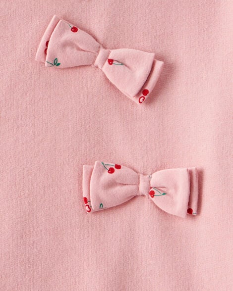 Detalle de monitos rosados con estampado de cerezas en sudadero Carters para niña