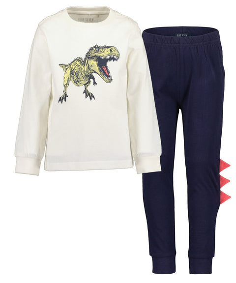 Pijama niño Blue Seven 2 piezas: camisa dinosaurio que brilla en la oscuridad y pantalón azul con picos rojos.