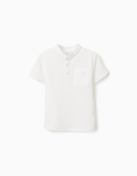Polo piqué blanco de manga corta Zippy para niño, con cuello mandarín y botones en la parte frontal.