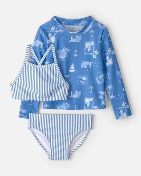 Set de natación Carters 3 piezas niña, vista frontal. Rash guard celeste estampado, top y calzoncito a rayas.