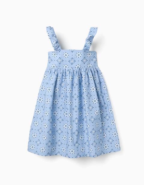 Vestido Zippy celeste para niña con estampado floral blanco y tirantes fruncidos.