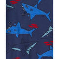 Detalle de tela azul oscuro con estampado de tiburones azules y peces para pijamas Carter's.