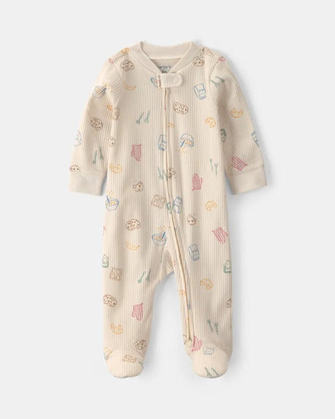 Pijama enterizo Carter's para bebé en color crema con estampado de desayuno, cierre y piecitos.